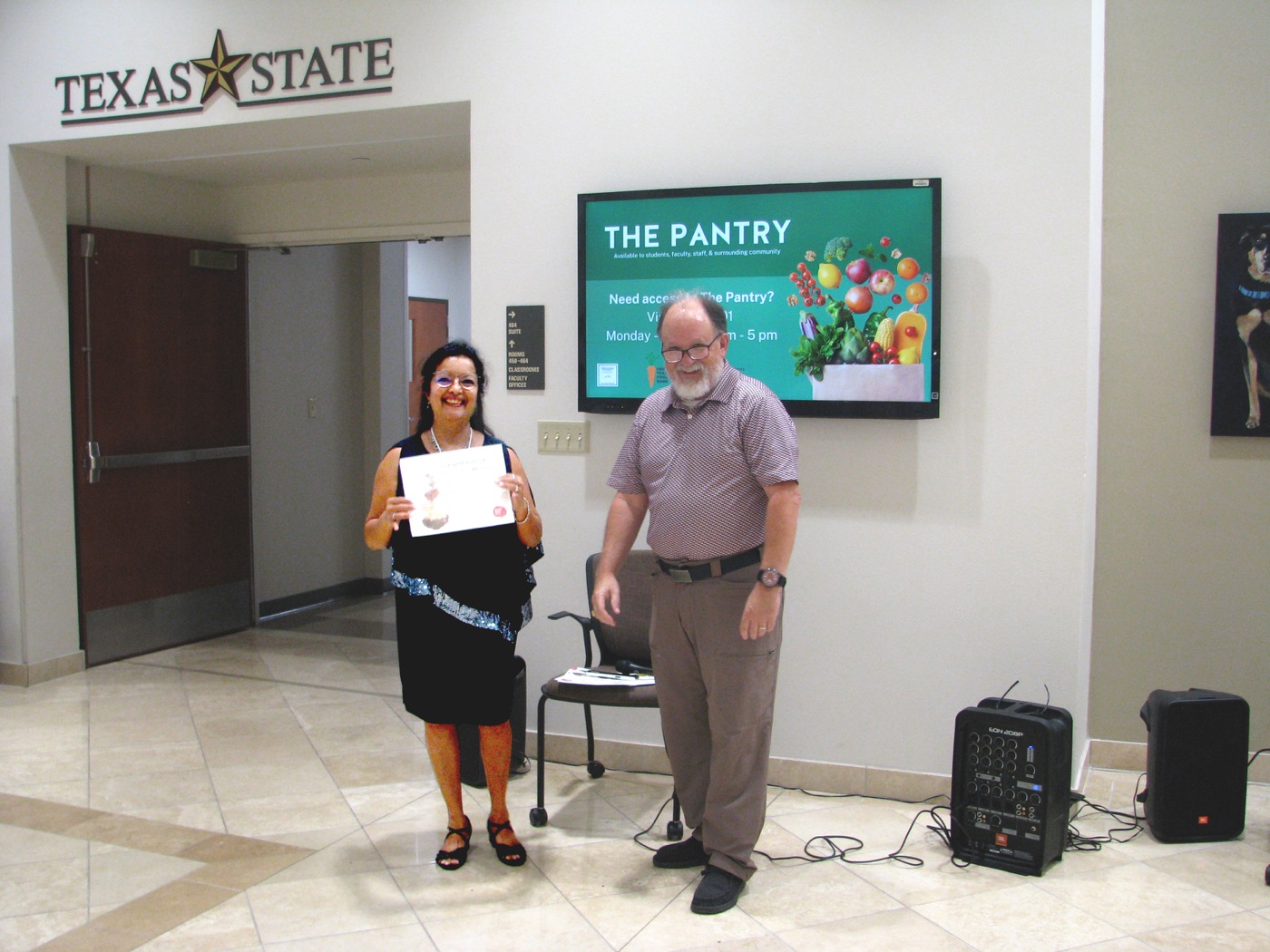 Nishi Kumar receiving the Honorable Mention award at Texas State University